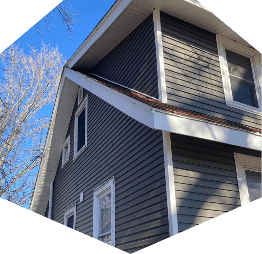 A side-angled view of a house with vinyl siding