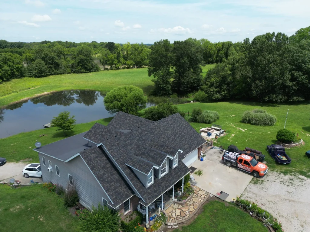 Aerial drone shot of a home with Resolve Roofing truck