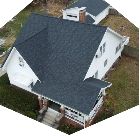 Aerial photo of a white home with dark shingles