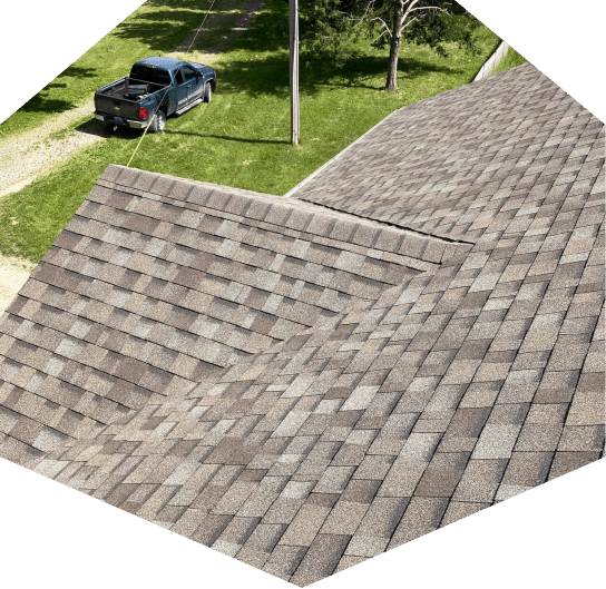 Roof shingles with parked truck nearby
