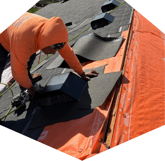 Person installing roofing materials outdoors