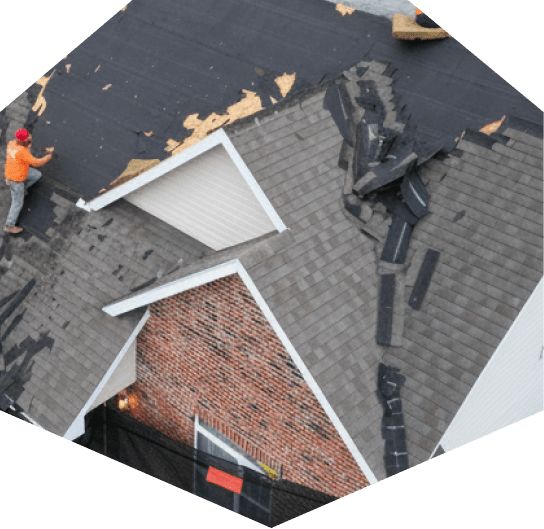 Workers repairing a residential roof.