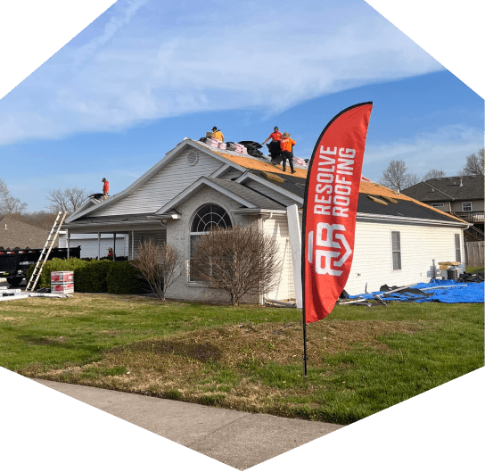 Roofing work in progress on house by Resolve Roofing Company