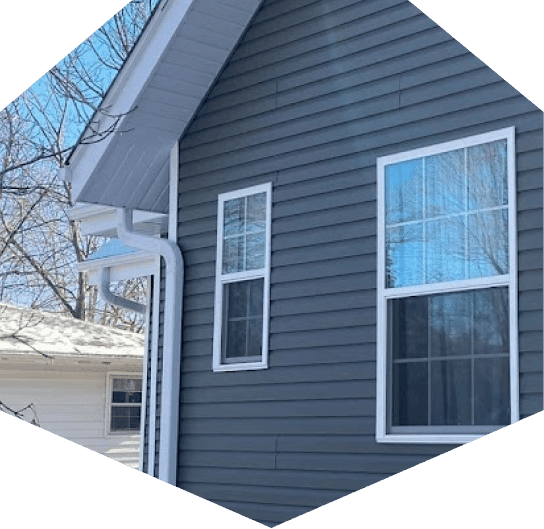 Gray house exterior with windows and gutters
