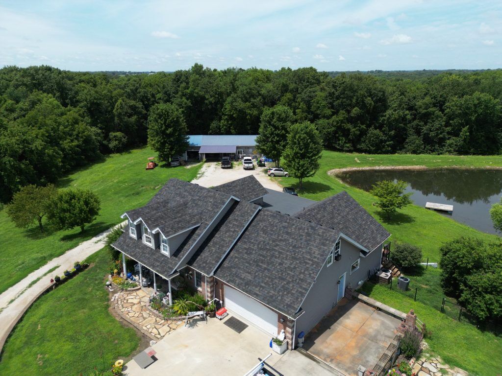 An asphalt shingle roof, prompting the question "Can You Put a New Roof Over Existing Shingles?"