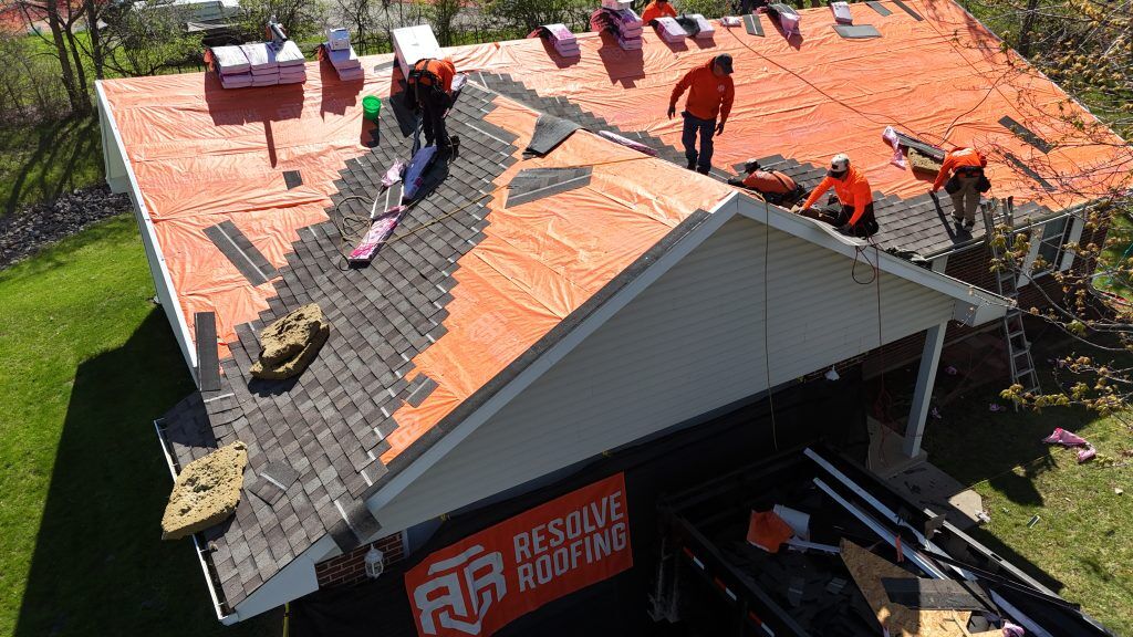A roof replacement in progress, prompting the question, "Can you replace a roof in the rain?"